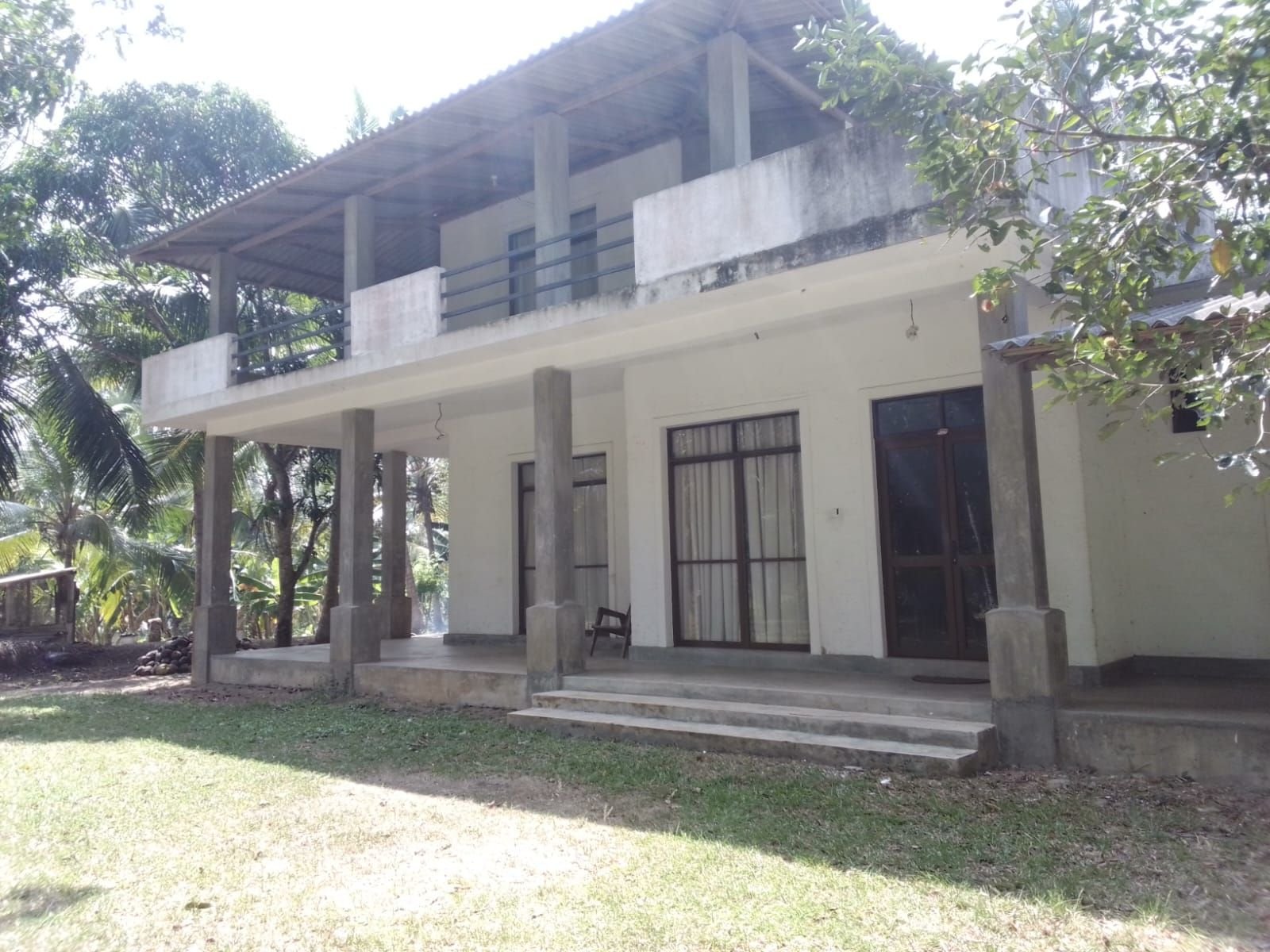 A coconut land for sale with a two storey bungalow in Pannalin